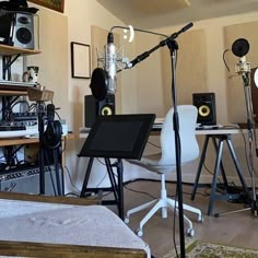 a recording studio with microphones, monitors and other equipment