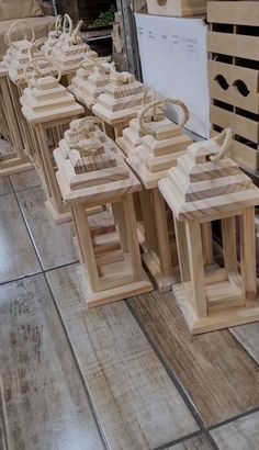 several wooden birdhouses are lined up on the floor