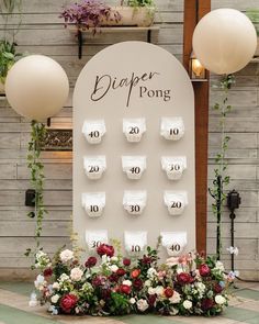 a display with flowers and paper pong on it