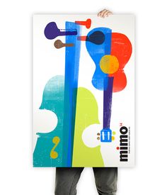 a person holding up a poster with an abstract design