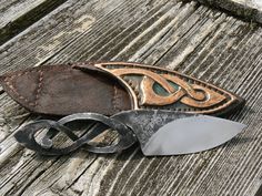 three different types of knives sitting on top of a wooden table