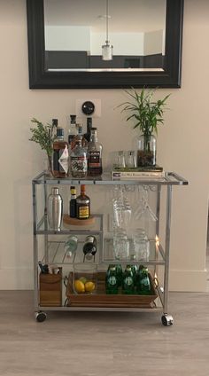 a bar cart filled with bottles and glasses