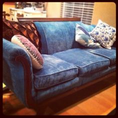 a blue couch with some pillows on it