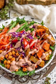 a salad in a bowl with dressing on top