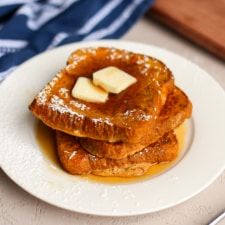 some food is on a white plate with blue and white napkins next to it