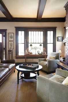 a living room with couches, chairs and a coffee table in front of a fireplace