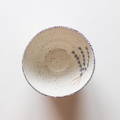 a white and blue bowl sitting on top of a table