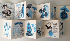 six folded cards with blue ink drawings on them