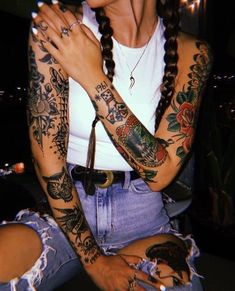 a woman with lots of tattoos on her arms