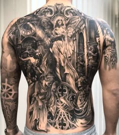 the back of a man's full body with many different tattoos on his chest