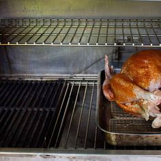 a roasted turkey sitting on top of a pan in an oven