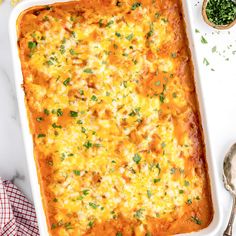 a casserole dish with cheese and parsley