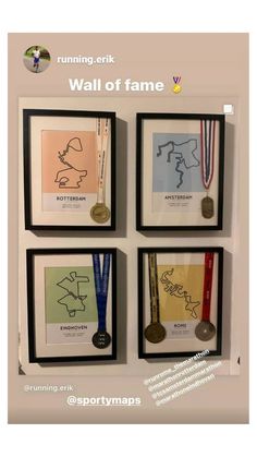 four framed pictures with medals hanging on the wall next to each other and one has a medal