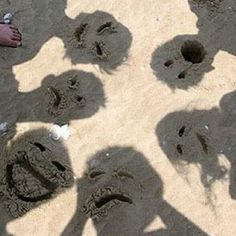 an image of someone's shadow in the sand with their hands and footprints on it