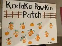 a sign that says kodak's paw -kin patch with pumpkins painted on it