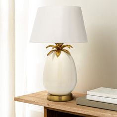 a table lamp with a white shade on it