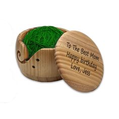 a wooden box filled with green yarn and the words to the best mom happy birthday love sees