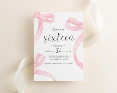 a pink ribbon is on top of a white card with the word, sweet sixteen