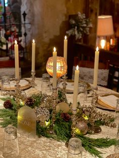 the table is set with candles and place settings