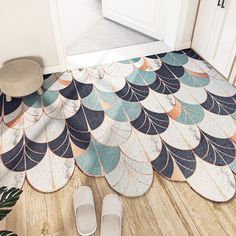 a pair of slippers sitting on top of a wooden floor next to a door