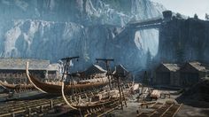 an old wooden boat sitting in front of a mountain