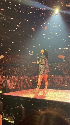 a man standing on top of a stage surrounded by confetti