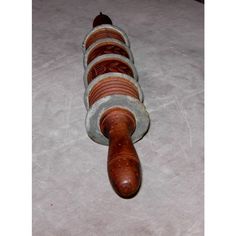 a close up of a wooden object on a white surface