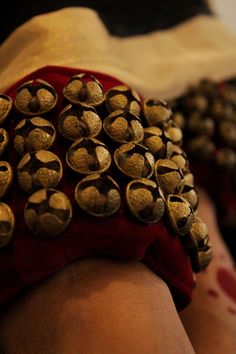 a close up of a person's arm with lots of gold studs on it