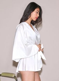 Our best selling Angel Sleeve Robe in luxe silk charmeuse. Features a playful fit with wide sleeves. Wraps across the body and is secured by a sash. Pair with the Gardenia Lace Demi Bra and Thong for an immaculate set. 92% Silk & 8% Spandex Dry clean only Model is 5'10 and wearing a size S/M. Bra And Thong, White Angel, Angel Sleeve, Angel Baby, Demi Bra, Silk Charmeuse, Wide Sleeves, Dry Clean, Angel