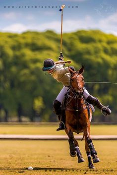 a polo player is riding a horse in the field