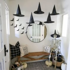 a hallway decorated for halloween with black witch hats on the wall