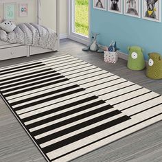 there is a black and white rug on the floor in this child's room