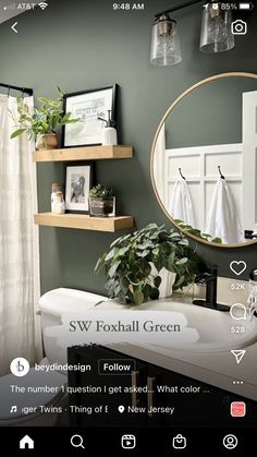 the bathroom is decorated in green and white with lots of greenery on the shelves