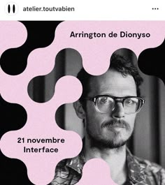 a man with glasses is standing in front of a pink and black poster that says arrington de dionyso