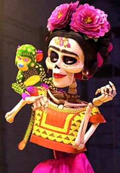 a woman in a skeleton costume holding a bird on her shoulder and wearing a flowered headdress