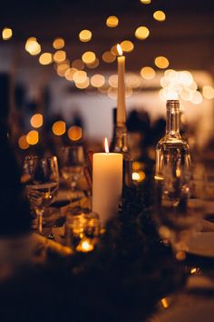 the table is set with wine glasses, candles and other things to enjoy in the evening