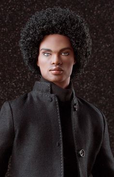 a man with an afro wearing a black jacket