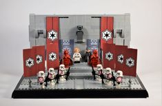 a lego star wars scene is displayed on a white surface with red and black accents