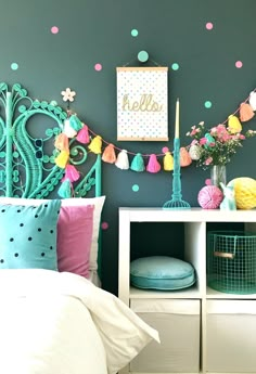 a bedroom decorated in pastel colors and polka dots