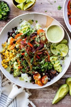 a white bowl filled with mexican salad next to avocado