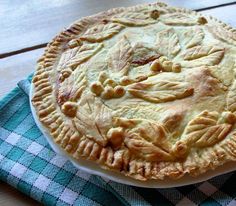 a pie sitting on top of a blue and white checkered cloth