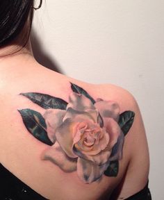 a woman with a rose tattoo on her shoulder