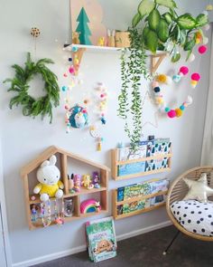 a room filled with lots of toys and plants on the wall next to bookshelves