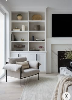 a living room filled with furniture and a flat screen tv mounted on the wall above a fireplace