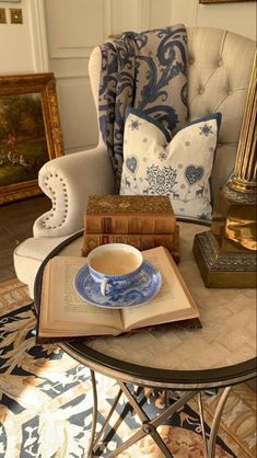 a coffee table with an open book on it and a cup of tea in the middle