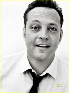 a black and white photo of a man wearing a shirt and tie with his eyes wide open