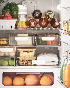 an open refrigerator filled with lots of different types of fruit and vegetables in containers on the shelves