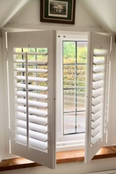 an open window with shutters on the inside