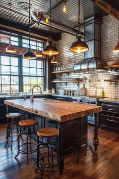 an industrial style kitchen with wood floors and black cabinets