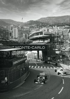 a black and white photo of a race car going under a bridge in monte - carlo